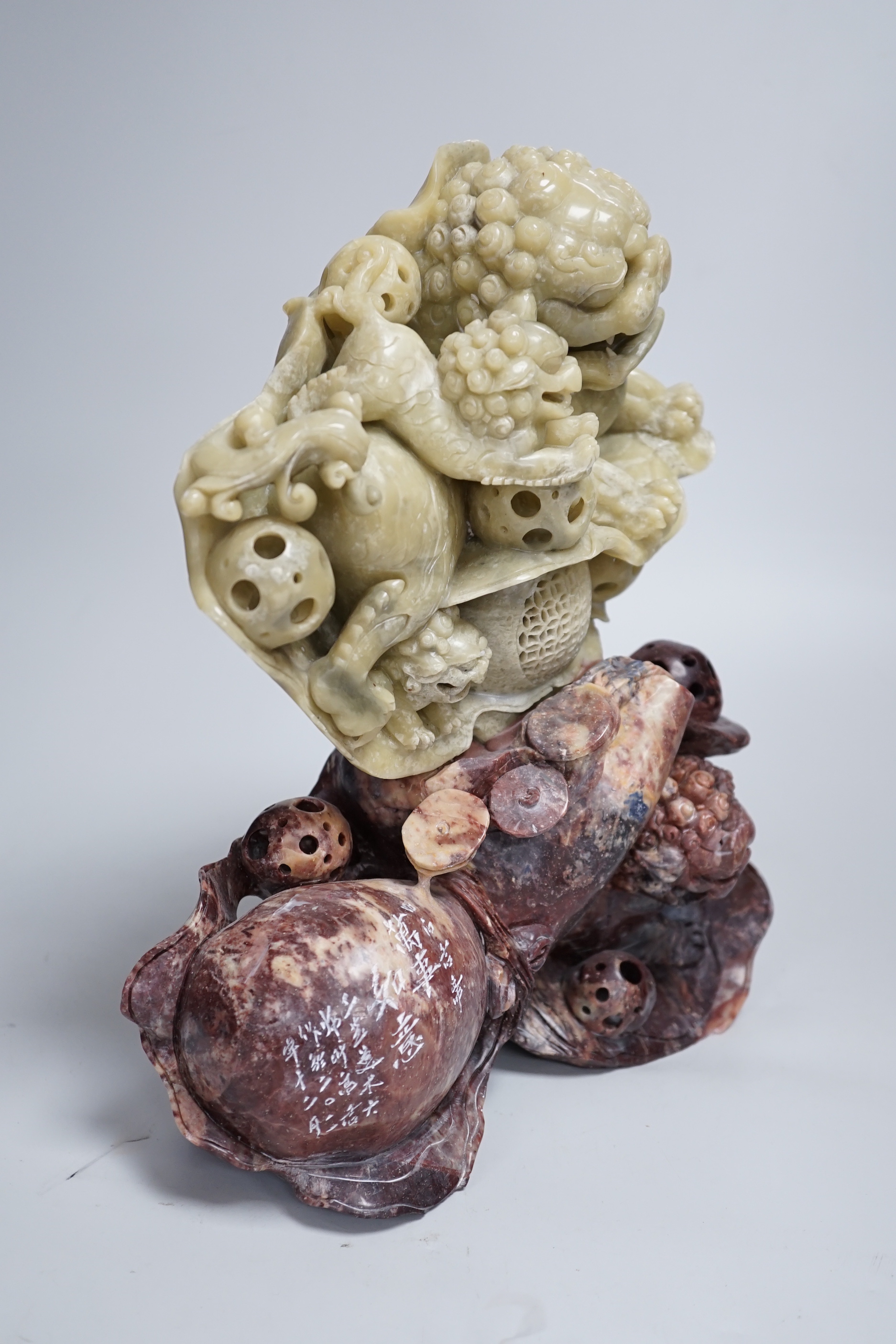 A Chinese soapstone sculpture of a lion dog group, 31.5cm high